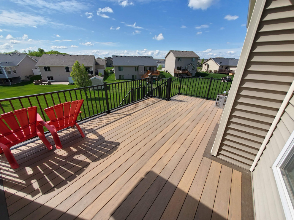 Deck - large backyard second story metal railing deck idea with a roof extension