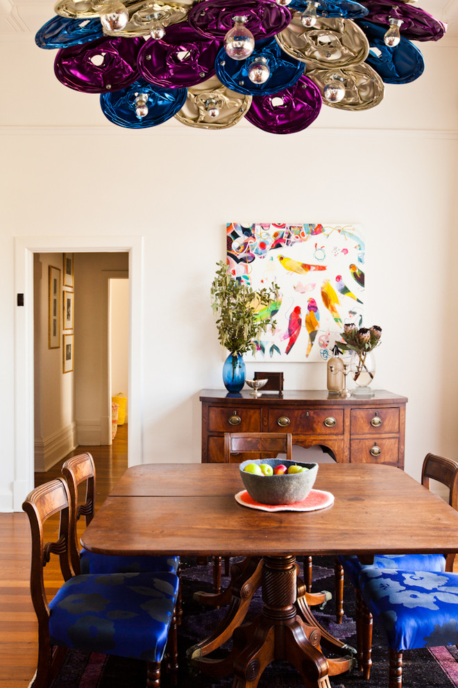 This is an example of an eclectic dining room in Perth with white walls and medium hardwood floors.