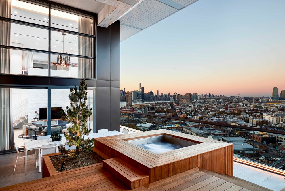 Trendy rooftop rooftop deck photo in New York with a roof extension