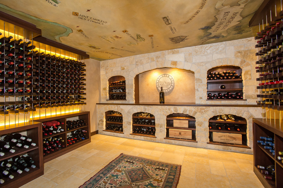 Design ideas for an expansive mediterranean wine cellar in Boston with limestone floors, storage racks and beige floor.