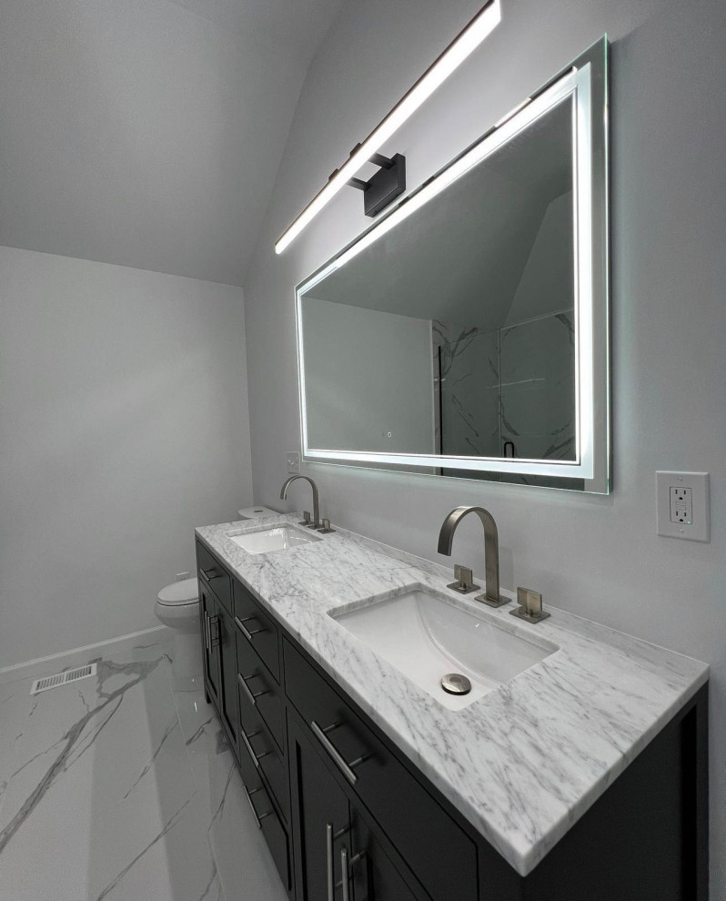 Design ideas for a large modern ensuite bathroom in New York with shaker cabinets, black cabinets, a freestanding bath, white tiles, porcelain tiles, white walls, porcelain flooring, a submerged sink, engineered stone worktops, white floors, white worktops, double sinks and a freestanding vanity unit.