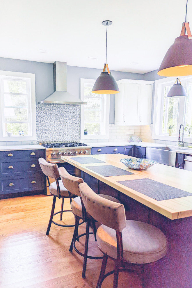 Exempel på ett mellanstort eklektiskt u-kök, med en rustik diskho, släta luckor, blå skåp, stänkskydd i mosaik, rostfria vitvaror, ljust trägolv och en köksö
