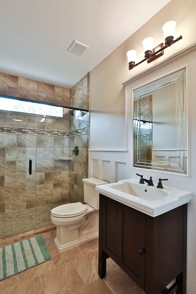 Inspiration for a mid-sized traditional 3/4 bathroom in Atlanta with an integrated sink, furniture-like cabinets, dark wood cabinets, an alcove shower, a two-piece toilet, beige tile, ceramic tile, beige walls and ceramic floors.