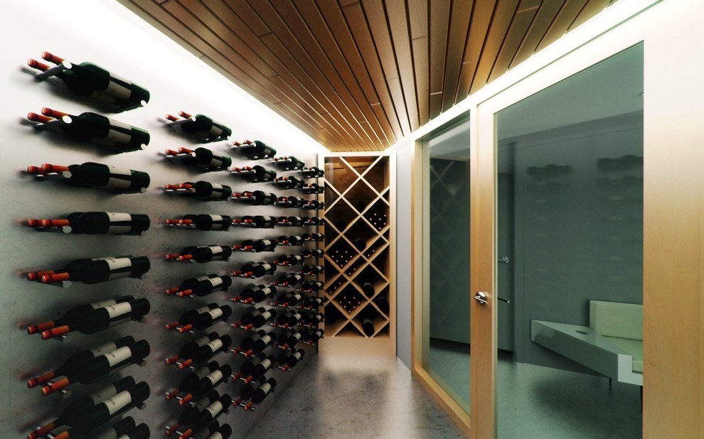 Mid-sized contemporary wine cellar in Montreal with concrete floors and display racks.