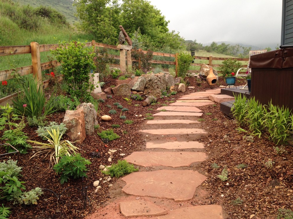 Design ideas for a large eclectic side yard full sun xeriscape in Denver with a garden path and natural stone pavers.