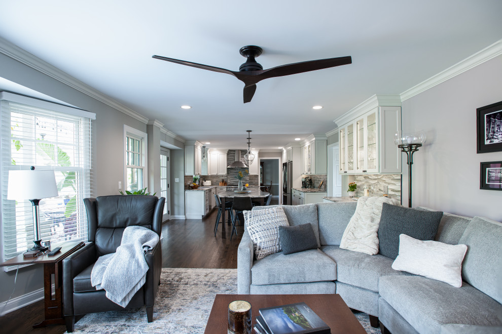 Mid-sized transitional u-shaped dark wood floor and brown floor open concept kitchen photo in Chicago with a double-bowl sink, shaker cabinets, white cabinets, quartz countertops, blue backsplash, porcelain backsplash, stainless steel appliances, an island and gray countertops