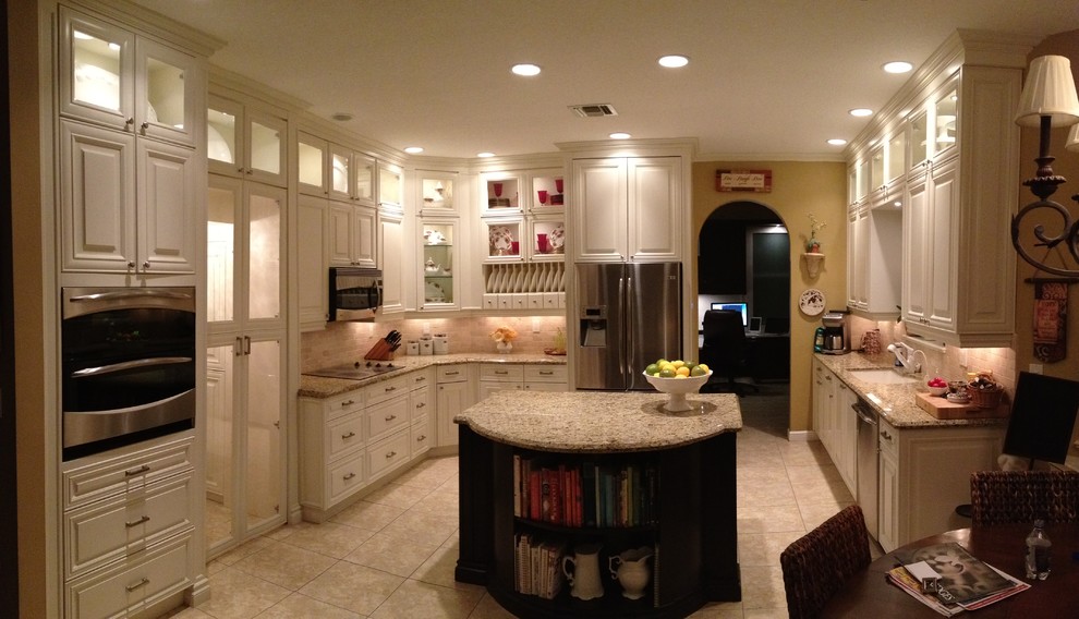 Large transitional u-shaped ceramic tile and beige floor open concept kitchen photo in Miami with a single-bowl sink, raised-panel cabinets, white cabinets, granite countertops, multicolored backsplash, stone tile backsplash, stainless steel appliances and an island