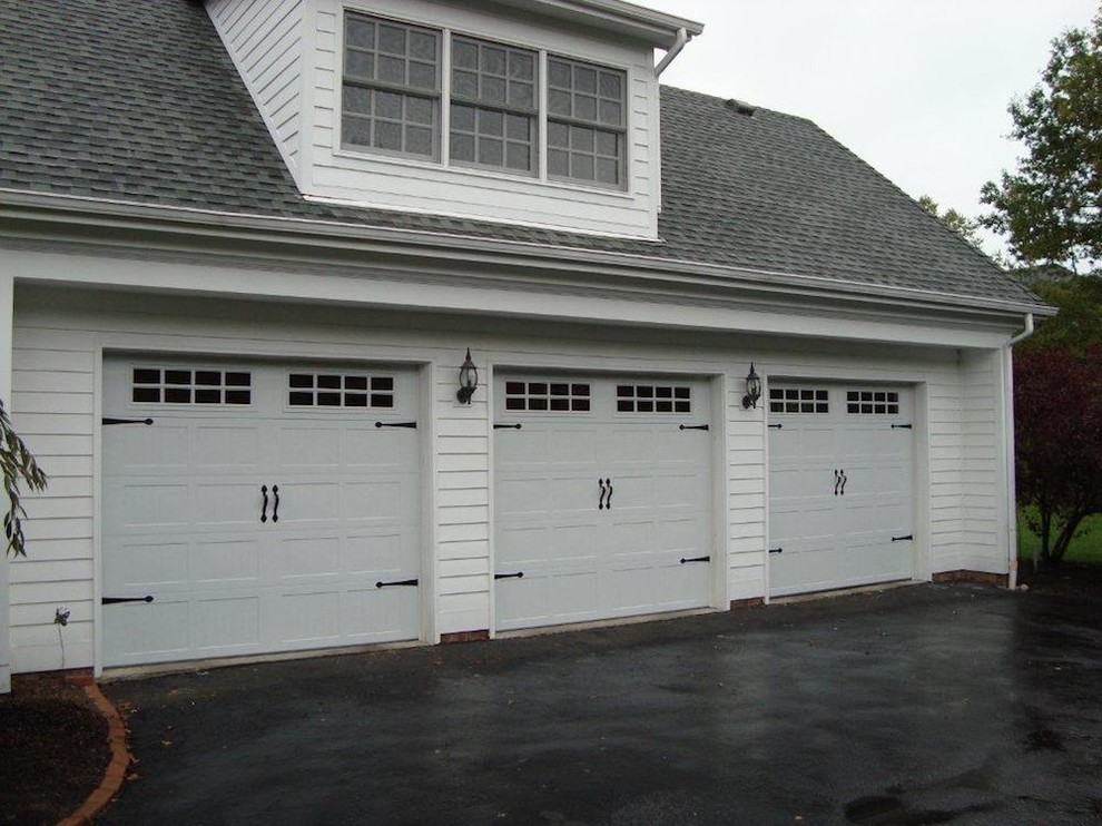 Photo of a large traditional attached three-car garage in New York.
