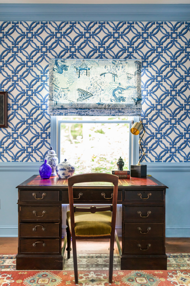 Photo of a mid-sized traditional home office in Cleveland with blue walls, medium hardwood floors, a freestanding desk and wallpaper.