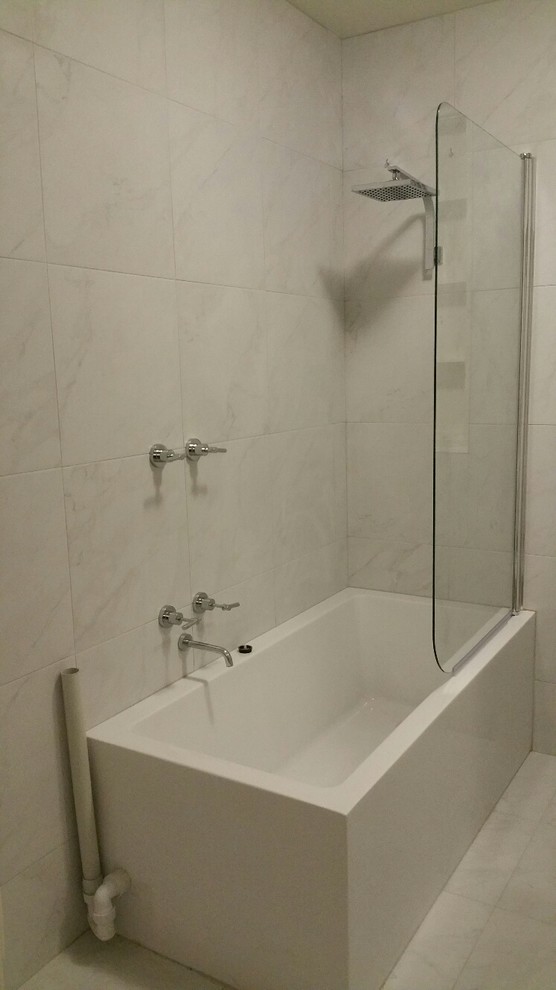Photo of a small modern master bathroom in Melbourne with flat-panel cabinets, white cabinets, an alcove tub, a shower/bathtub combo, a two-piece toilet, white tile, an integrated sink, laminate benchtops, white floor, an open shower, ceramic tile, white walls, ceramic floors and grey benchtops.