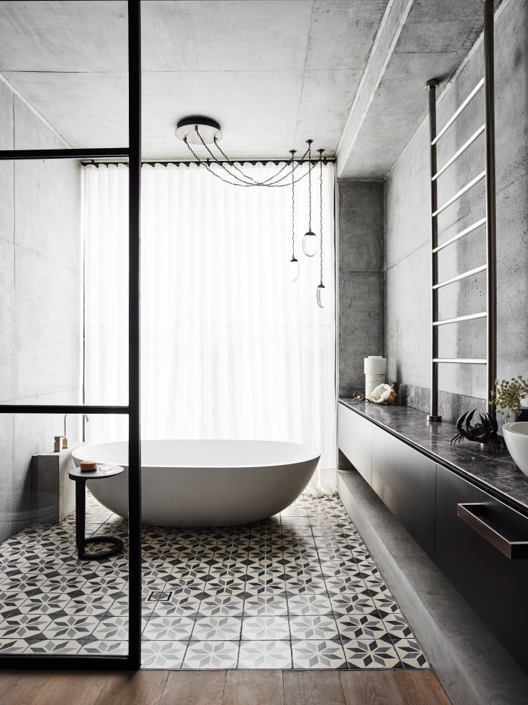 Inspiration for a large contemporary bathroom in Sydney with flat-panel cabinets, black cabinets, a freestanding tub, grey walls, a vessel sink, multi-coloured floor, black benchtops, a single vanity, a floating vanity, an open shower, cement tiles and an open shower.