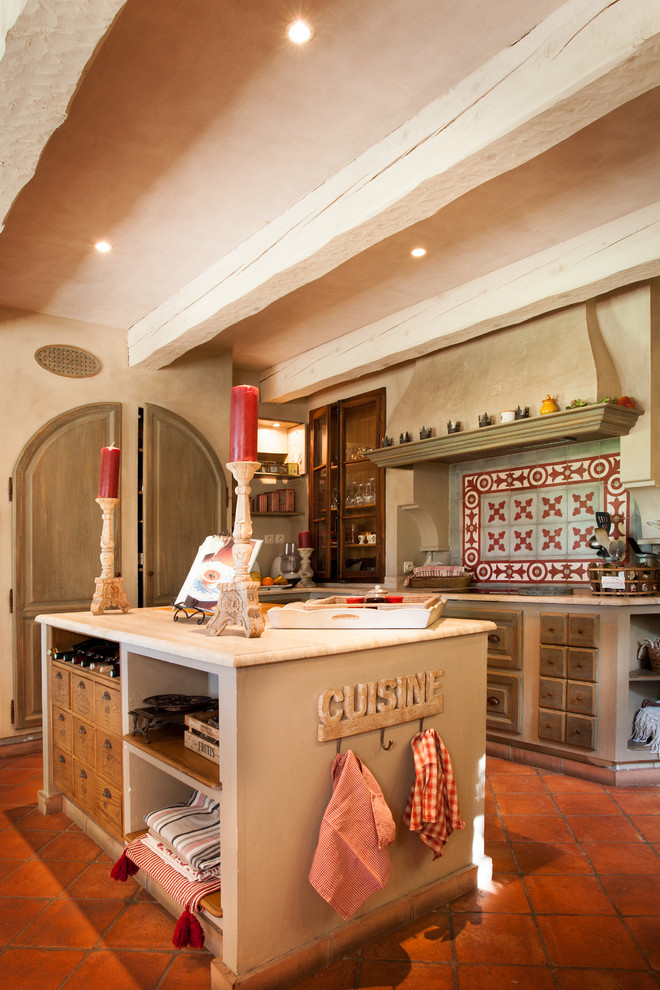This is an example of a country galley separate kitchen in Marseille with distressed cabinets and with island.