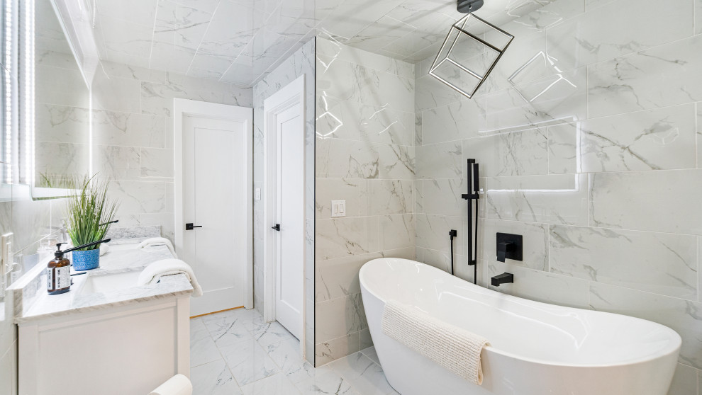 Photo of a mid-sized traditional master bathroom in San Francisco with shaker cabinets, medium wood cabinets, a freestanding tub, an alcove shower, a one-piece toilet, black and white tile, ceramic tile, porcelain floors, a drop-in sink, granite benchtops, white floor, a hinged shower door, white benchtops, a shower seat, a double vanity, a freestanding vanity, exposed beam and decorative wall panelling.