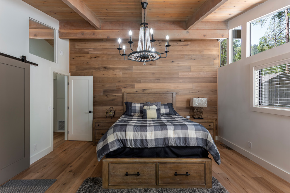 Inspiration for a country bedroom in Los Angeles with brown walls, medium hardwood floors and brown floor.