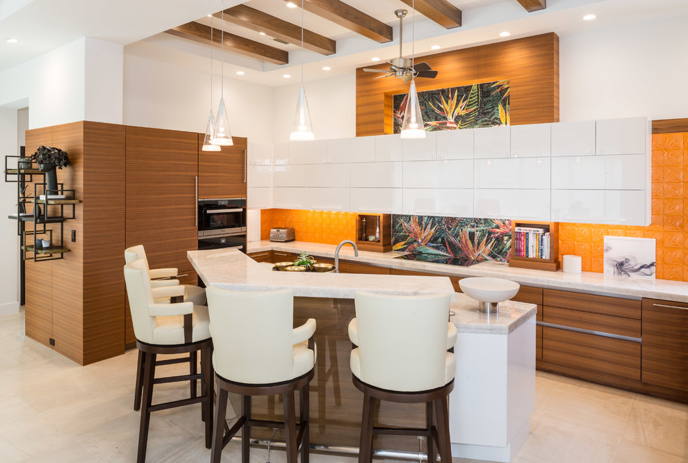 Inspiration for a mid-sized transitional l-shaped kitchen in Tampa with an undermount sink, flat-panel cabinets, medium wood cabinets, granite benchtops, orange splashback, stainless steel appliances and with island.
