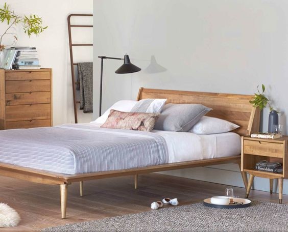 Inspiration for a mid-sized scandinavian bedroom in Portland with white walls, light hardwood floors, no fireplace and brown floor.