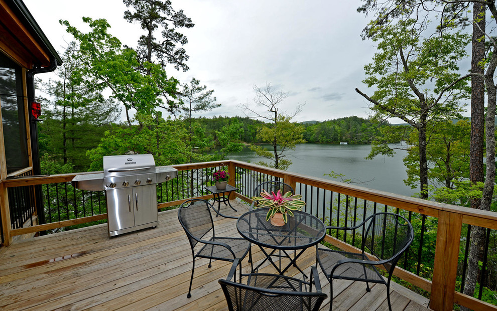 Deck - large rustic backyard deck idea with no cover