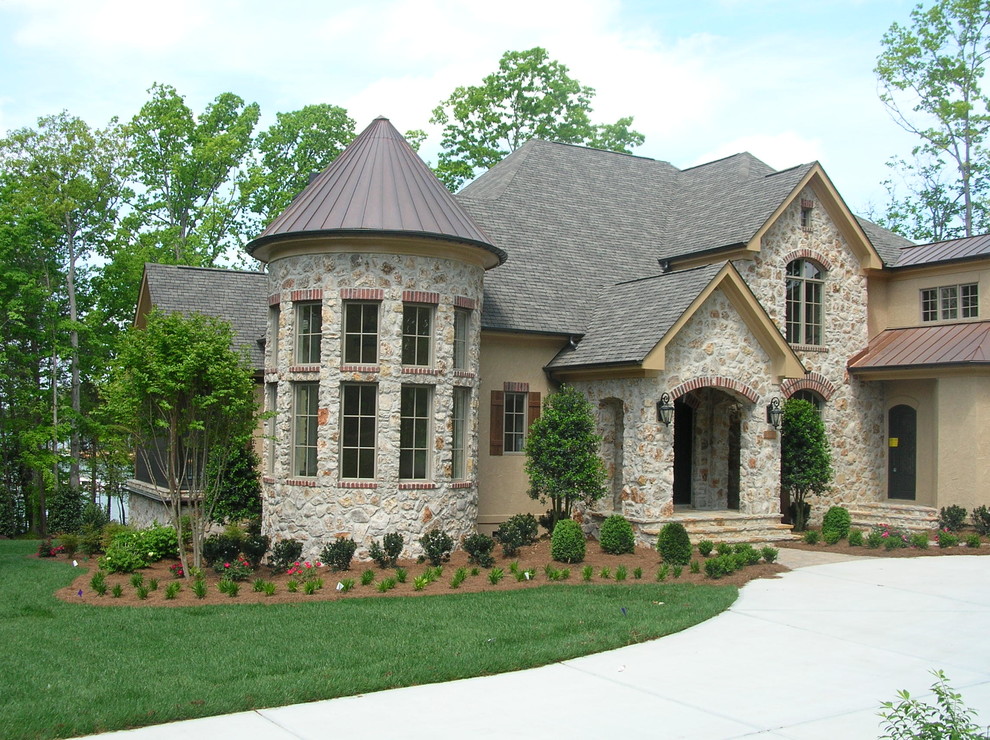 Large eclectic two-storey brown exterior in Charlotte with stone veneer.