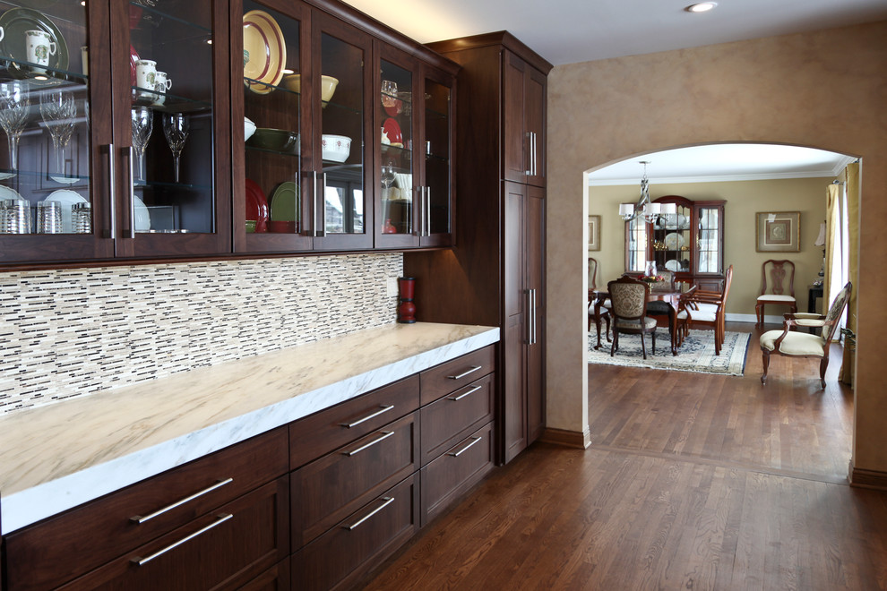 Transitional medium tone wood floor kitchen photo in Chicago with an undermount sink, shaker cabinets, dark wood cabinets, wood countertops, multicolored backsplash, ceramic backsplash and stainless steel appliances