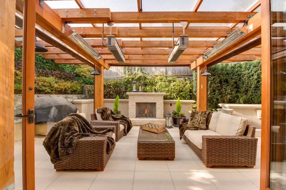 Inspiration for a transitional patio in Vancouver with a pergola and with fireplace.