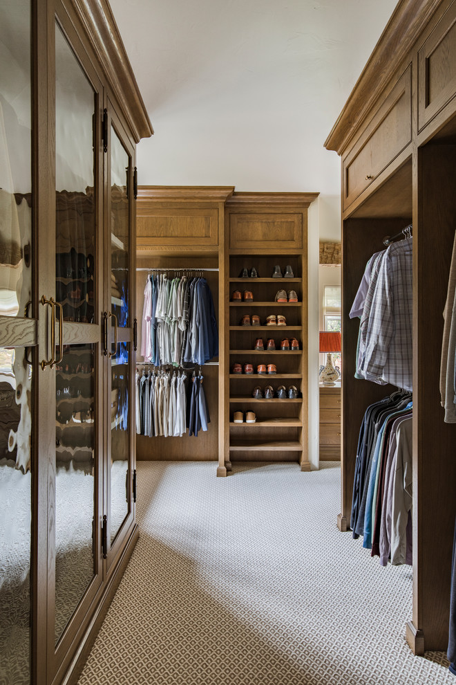 Design ideas for a large traditional men's dressing room in Portland with beaded inset cabinets, carpet and medium wood cabinets.