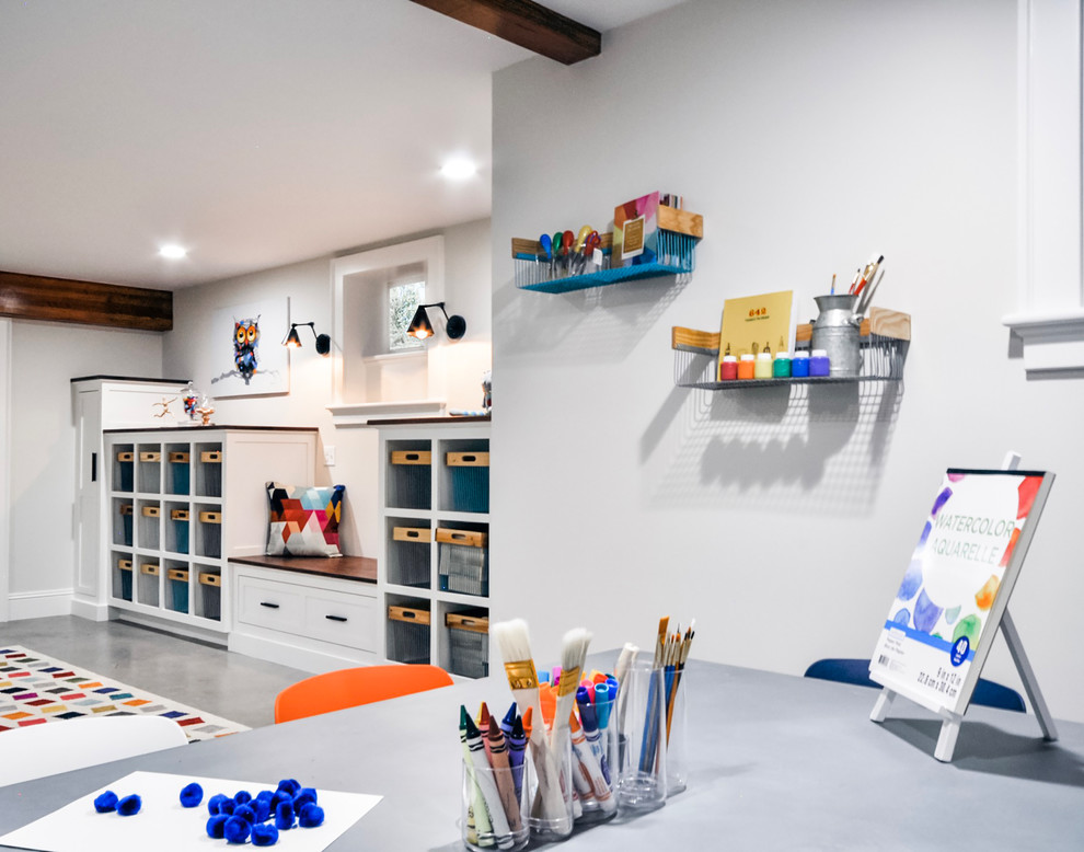 Design ideas for a large transitional gender-neutral kids' playroom for kids 4-10 years old in Newark with white walls, concrete floors and grey floor.