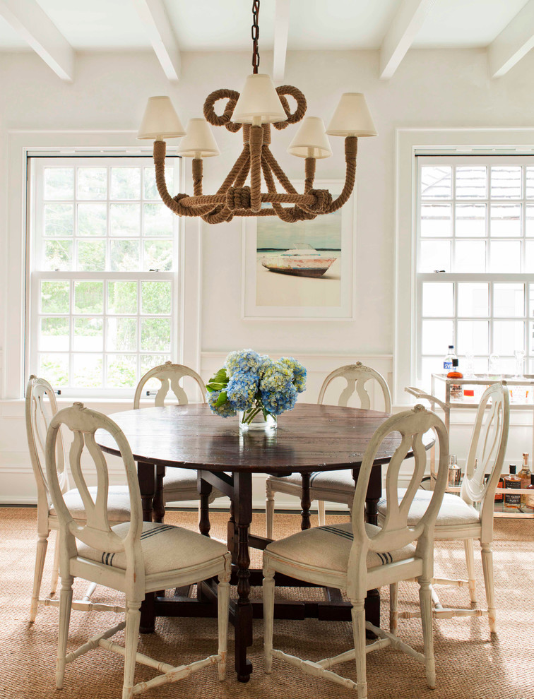 Mid-sized beach style open plan dining in New York with white walls, light hardwood floors and no fireplace.