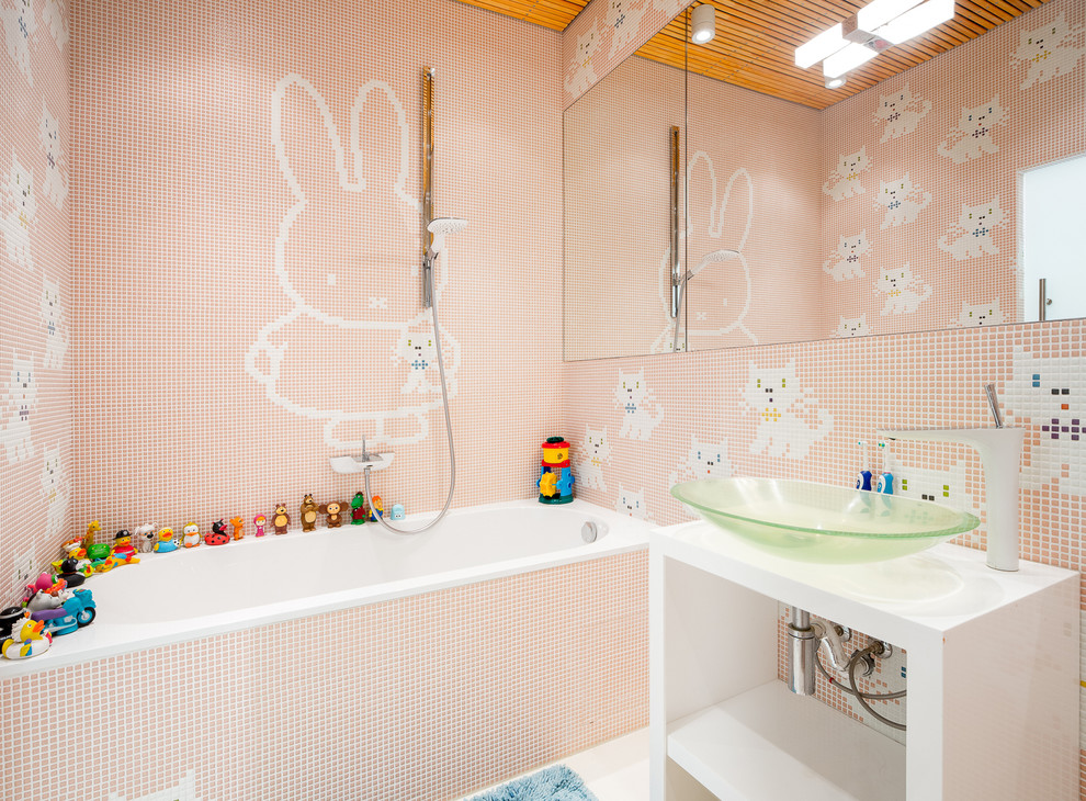 This is an example of a contemporary kids bathroom in Other with an alcove tub, a shower/bathtub combo, multi-coloured tile, mosaic tile, pink walls and a vessel sink.