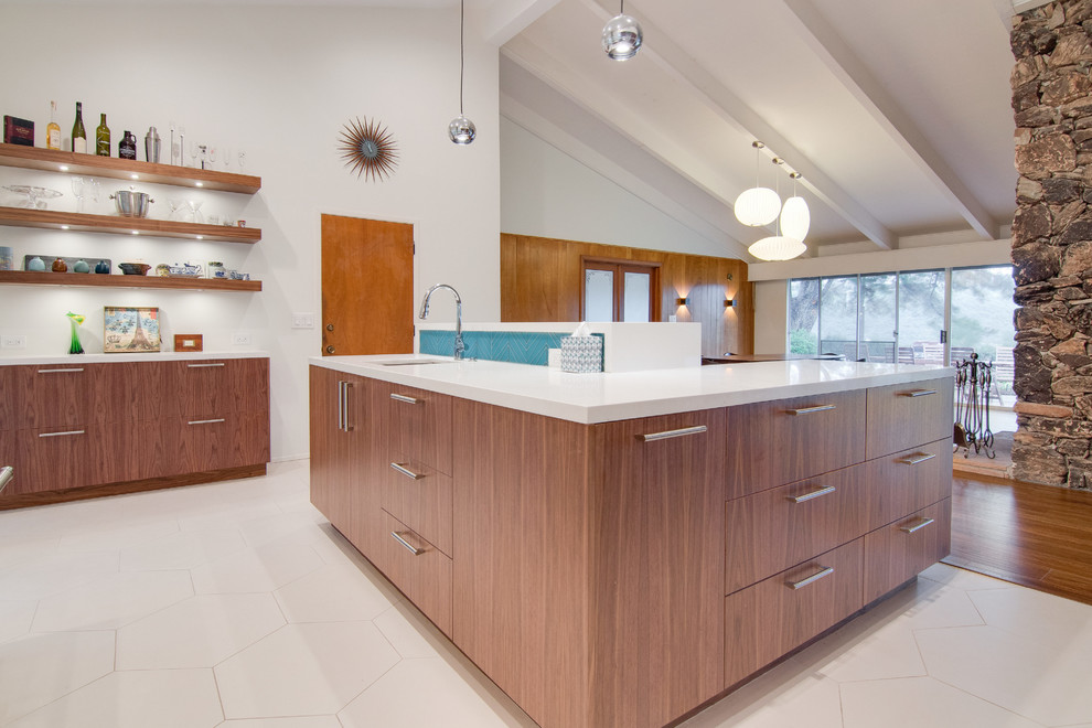 Inspiration for a large midcentury u-shaped open plan kitchen in Tampa with an undermount sink, flat-panel cabinets, dark wood cabinets, blue splashback, glass sheet splashback, stainless steel appliances, porcelain floors and multiple islands.