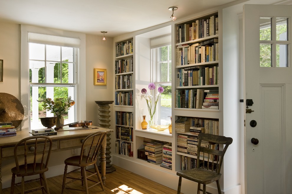 Photo of a traditional home office in Burlington with a library and medium hardwood floors.