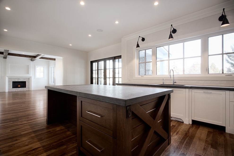 Inspiration for a large transitional u-shaped eat-in kitchen remodel in Calgary with shaker cabinets, paneled appliances and an island