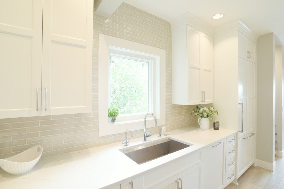 Transitional ceramic tile kitchen photo in Seattle with shaker cabinets, white cabinets, quartzite countertops, subway tile backsplash, stainless steel appliances, an island and white countertops