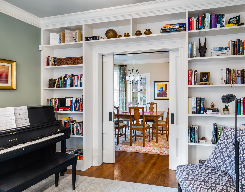 This is an example of a mid-sized traditional enclosed living room in Boston with a music area, green walls, medium hardwood floors and brown floor.