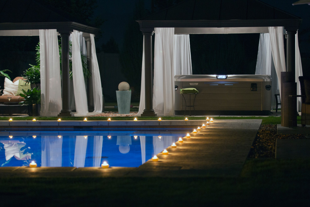 Inspiration for a mid-sized transitional backyard rectangular hot tub remodel