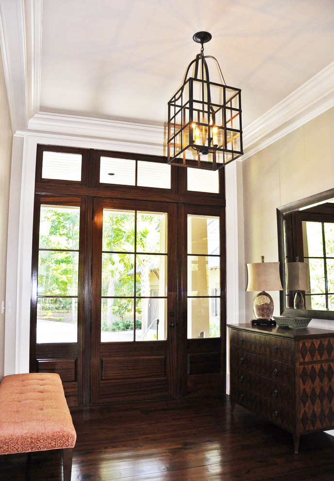 Inspiration for a mid-sized timeless dark wood floor entryway remodel in Charleston with beige walls and a glass front door