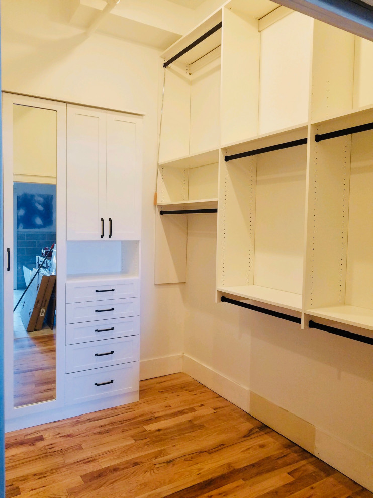 Design ideas for a large contemporary storage and wardrobe in Other with raised-panel cabinets.