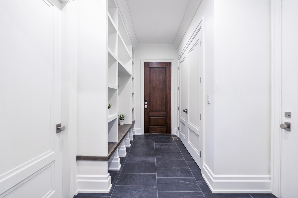 Mid-sized transitional mudroom in New York with white walls, slate floors, a single front door, a dark wood front door and black floor.