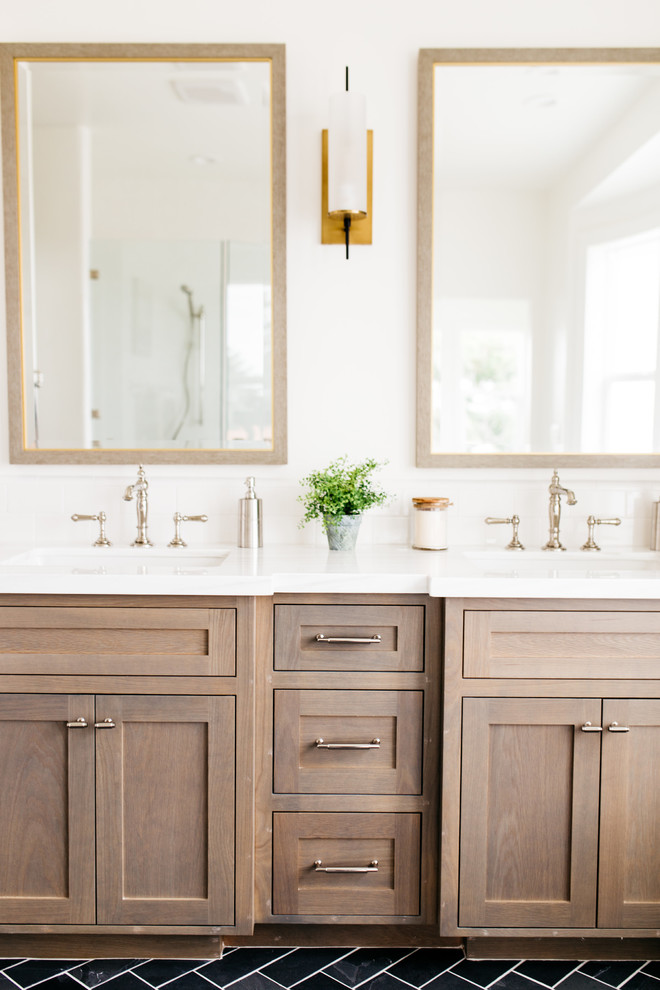 Inspiration for a large country master bathroom in San Diego with shaker cabinets, dark wood cabinets, a freestanding tub, white walls, porcelain floors, an undermount sink, engineered quartz benchtops and black floor.