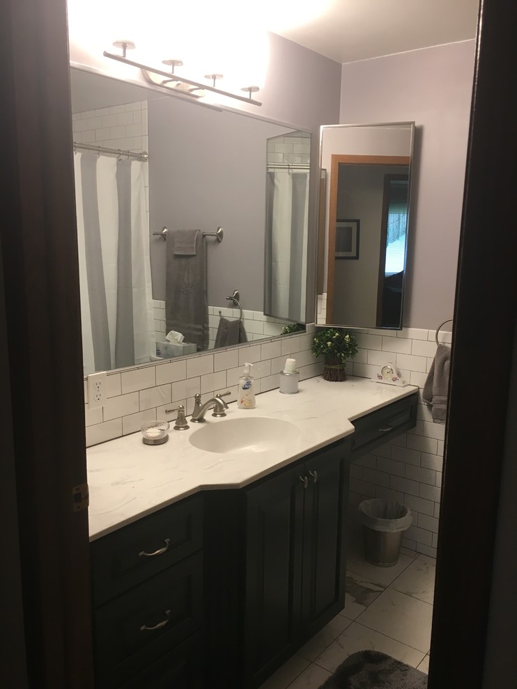 This is an example of a small transitional master bathroom in Chicago with raised-panel cabinets, grey cabinets, an alcove tub, an alcove shower, a two-piece toilet, white tile, ceramic tile, purple walls, porcelain floors, an integrated sink, onyx benchtops, white floor and a shower curtain.
