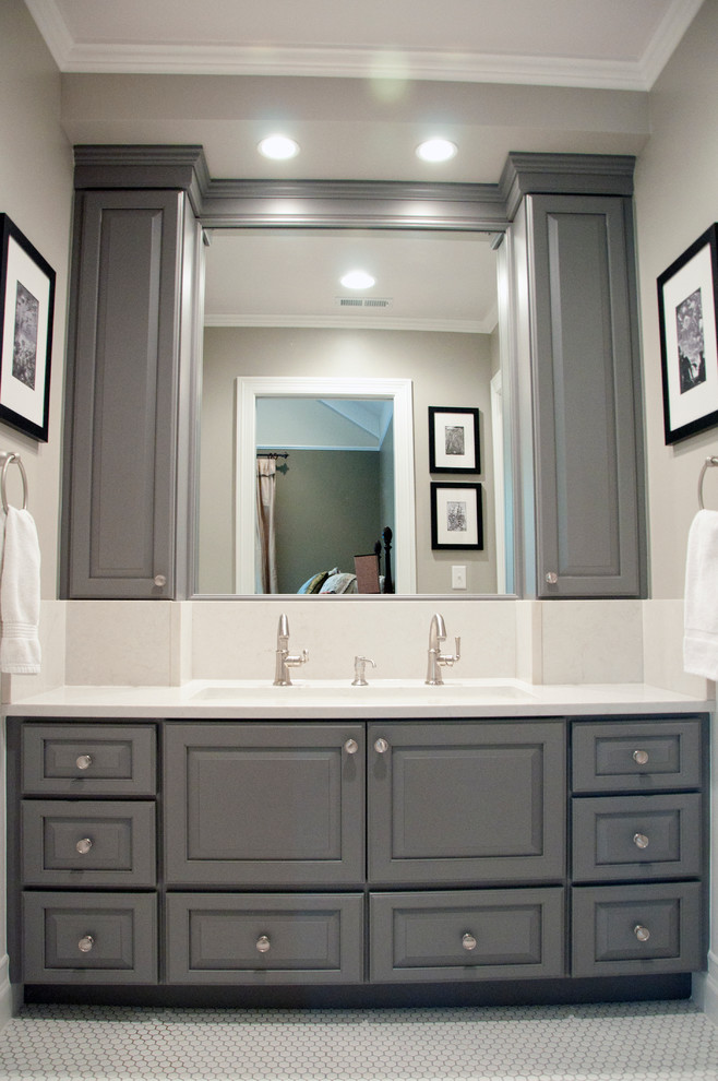 This is an example of a mid-sized eclectic bathroom in Nashville with a trough sink, raised-panel cabinets, grey cabinets, engineered quartz benchtops, an alcove tub, a two-piece toilet, white tile, porcelain tile, grey walls, mosaic tile floors, white floor, white benchtops, a shower/bathtub combo and a shower curtain.