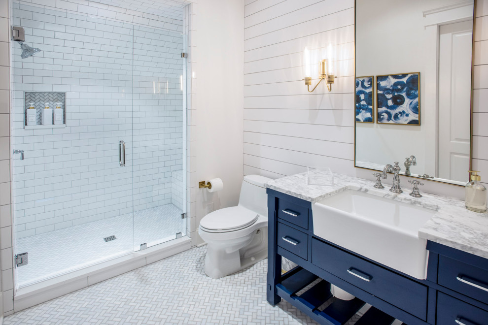 Inspiration for a mid-sized country kids' white tile single-sink bathroom remodel in Nashville with beaded inset cabinets, light wood cabinets, a two-piece toilet, white walls, an integrated sink, marble countertops, a hinged shower door, white countertops and a freestanding vanity