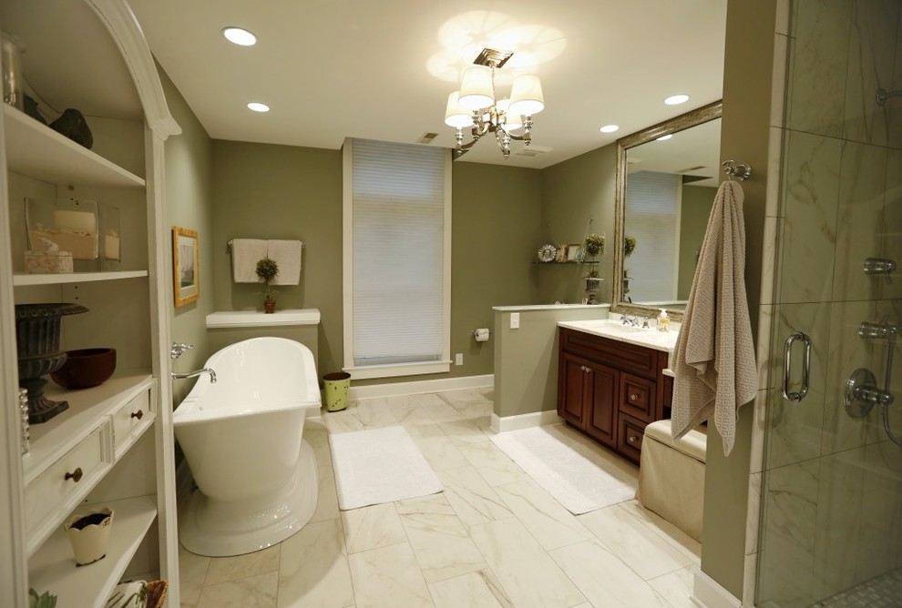 Mid-sized transitional master bathroom in San Diego with raised-panel cabinets, dark wood cabinets, a freestanding tub, an alcove shower, a one-piece toilet, green walls, porcelain floors and an integrated sink.