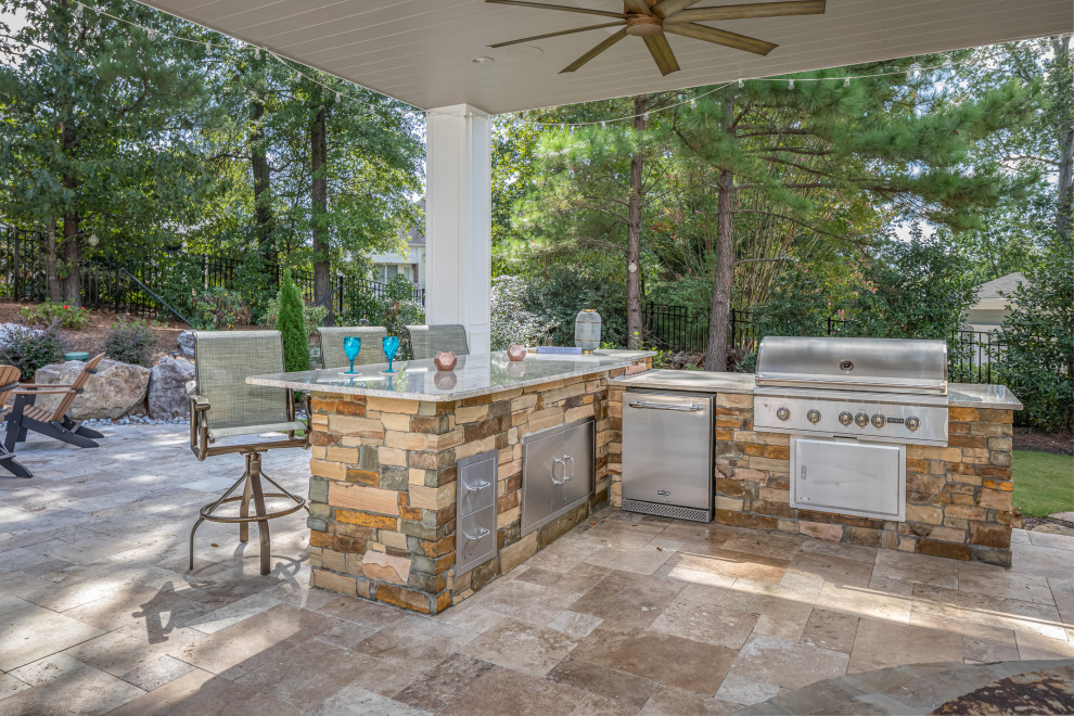 Design ideas for a large transitional backyard patio with an outdoor kitchen, tile and a roof extension.