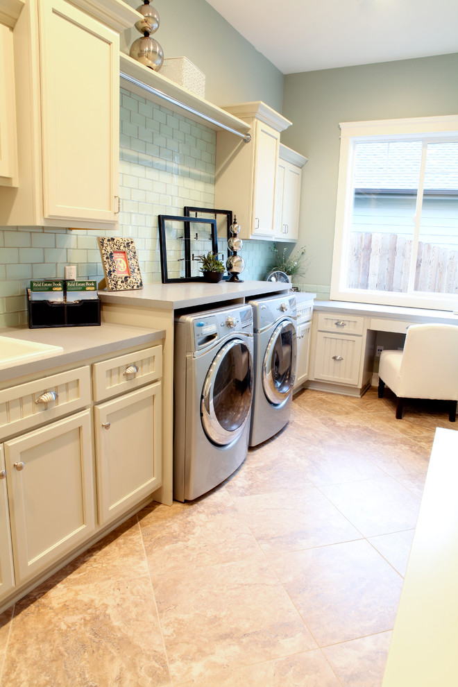 Traditional laundry room in Seattle with white cabinets.