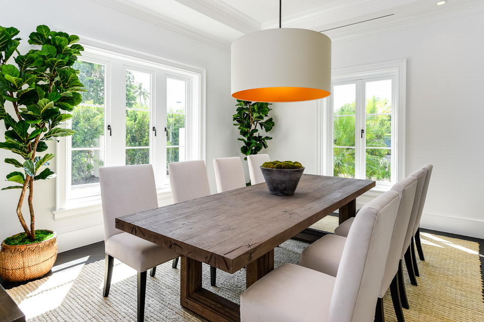 Photo of a transitional dining room in Miami with white walls, dark hardwood floors and brown floor.
