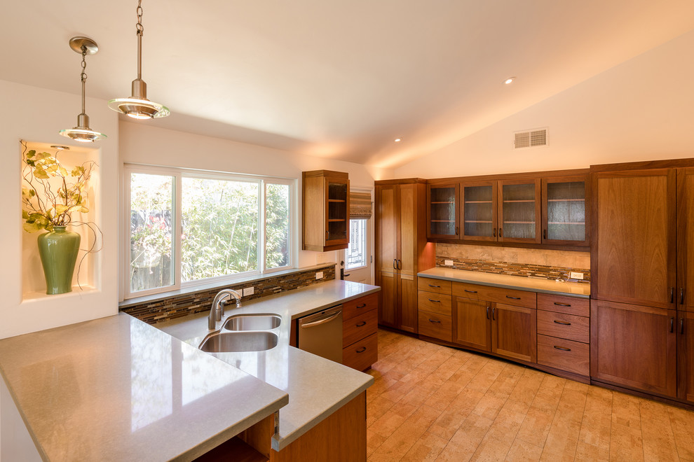 This is an example of an expansive arts and crafts u-shaped eat-in kitchen in Santa Barbara with a double-bowl sink, shaker cabinets, medium wood cabinets, quartz benchtops, multi-coloured splashback, slate splashback, stainless steel appliances, cork floors, a peninsula and brown floor.