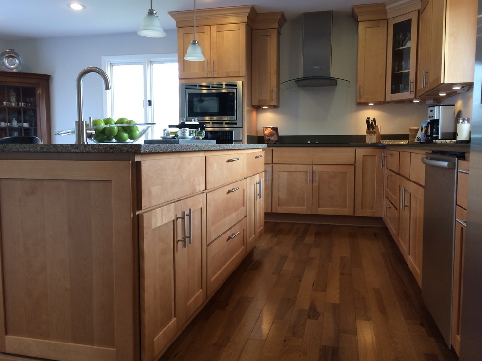 Mid-sized transitional u-shaped light wood floor open concept kitchen photo with an undermount sink, shaker cabinets, light wood cabinets, quartz countertops, stainless steel appliances and an island