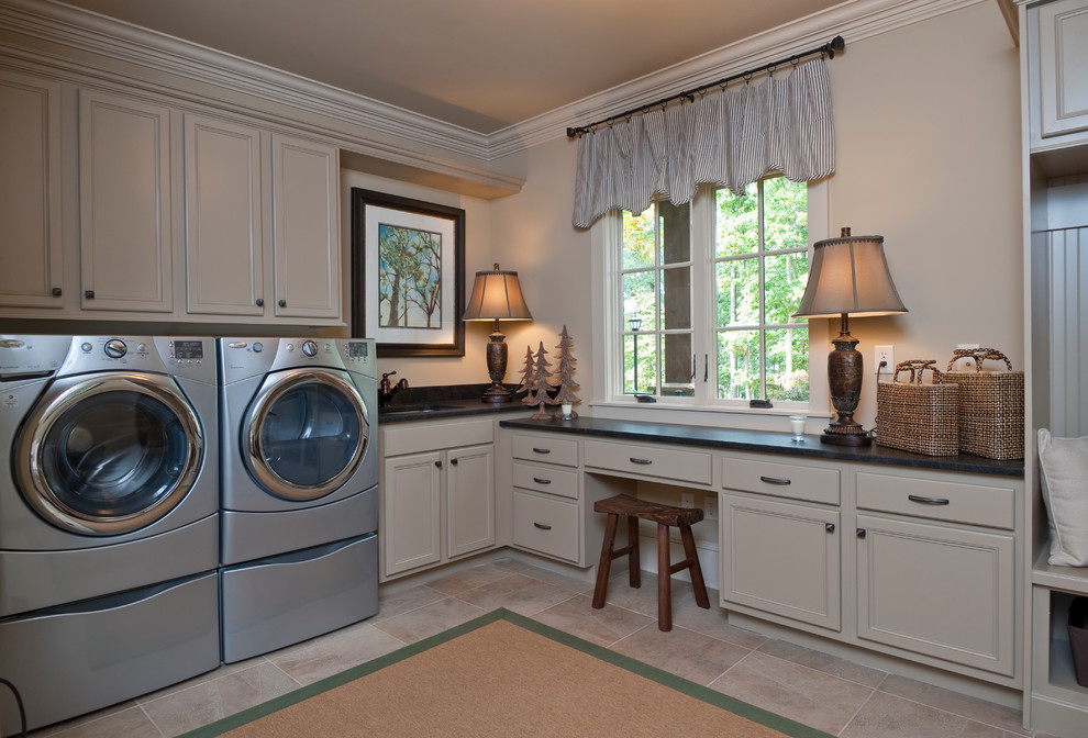 Design ideas for a traditional laundry room in Other with beige cabinets, a side-by-side washer and dryer and beige floor.