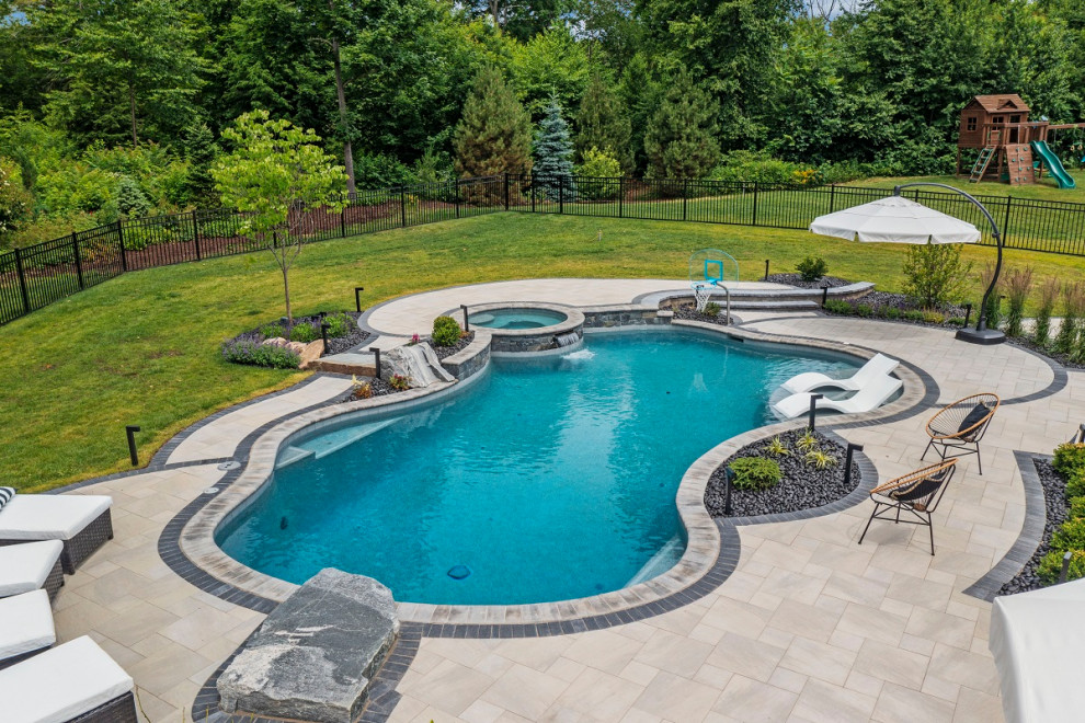 Design ideas for a large modern back custom shaped natural hot tub in Bridgeport with concrete paving.