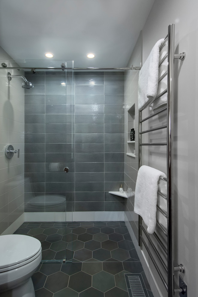 This is an example of a mid-sized midcentury master bathroom in Seattle with flat-panel cabinets, brown cabinets, a curbless shower, a two-piece toilet, ceramic tile, grey walls, porcelain floors, an undermount sink, engineered quartz benchtops, a sliding shower screen, white benchtops, gray tile and green floor.